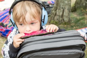 A Summers Tale-Festival mit Kind: Kind spielt Mundharmonika